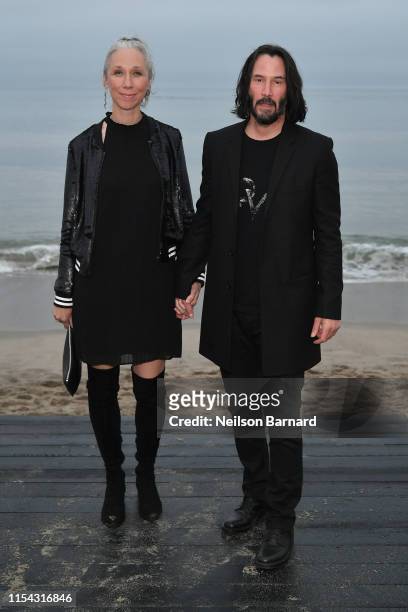 Alexandra Grant and Keanu Reeves attend the Saint Laurent Mens Spring Summer 20 Show Photo Call on June 06, 2019 in Malibu, California.