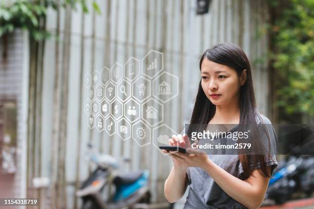 young lady using 5g on her smartphone - smart city life stock pictures, royalty-free photos & images