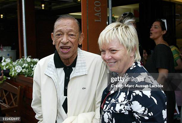 Henri Salvador and his wife pose in the 'Village', the VIP area of the French Open at Roland Garros arena in Paris, France on June 3, 2007.