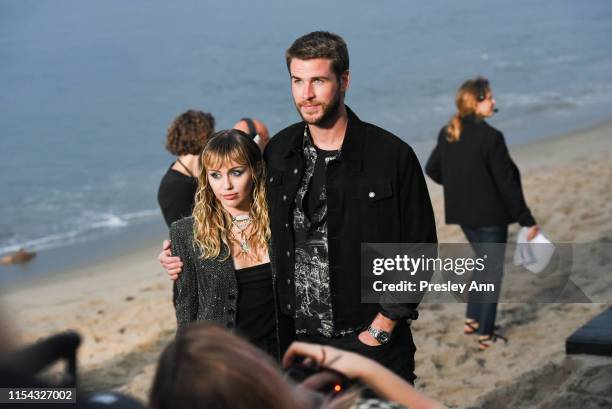 Miley Cyrus and Liam Hemsworth at Saint Laurent mens spring summer 20 show on June 06, 2019 in Malibu, California.