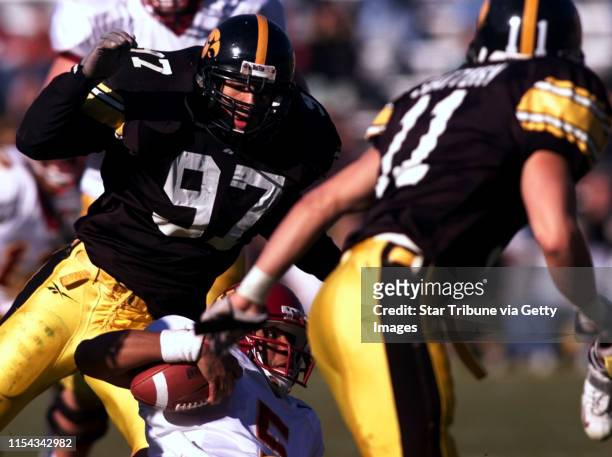 Gophers at Iowa -- Minnesota quateback Billy Cockerham slides to avoid a hit by Iowa defenders LeVar Woods and Joe Slattery during 3rd quarter action...