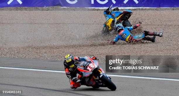 Dynavolt Intact's Swiss rider Thomas Luthi steers his bike as EG 0,0 Marc VDS's Spanish rider Xavi Vierge falls during the Moto2 race at the Grand...