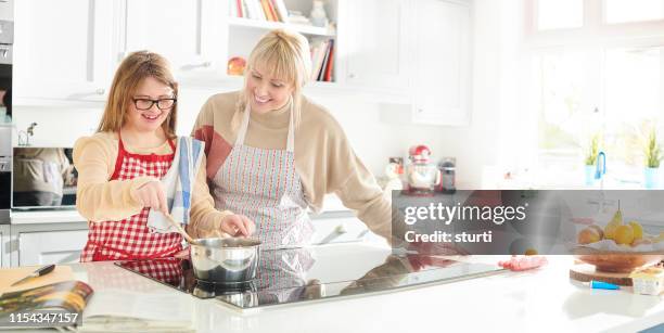 mother and daughter cooking fun - electric stove burner stock pictures, royalty-free photos & images