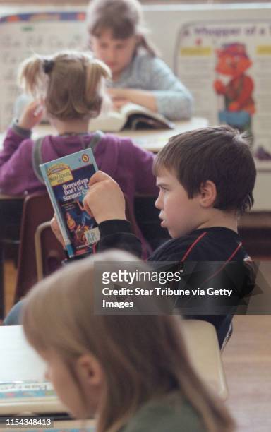 St. Paul, MN., Wednesday, 3/21/2001. Randolph Heights Elementary third grader Zach Bastyr read with fellow students in the class room of Beth...