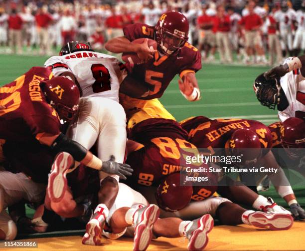 Minneapolis - Gophers vs. Indianna football -- Gopher quarterback Billy Cockerham dives over the top of the Minnesota line to score a go-ahead...