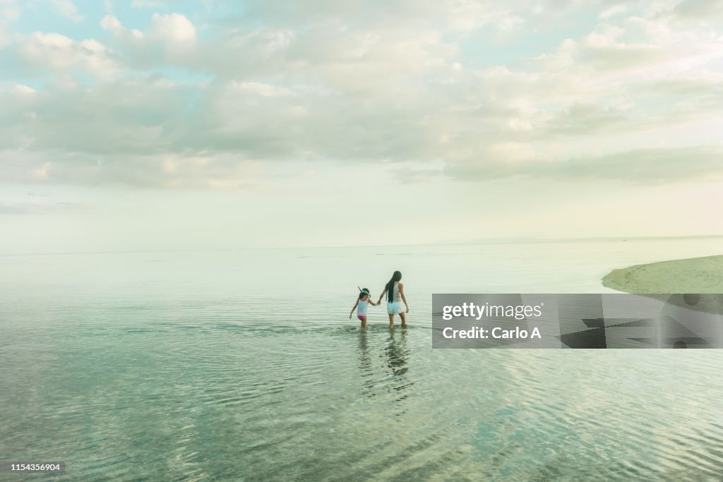 Mother and daughter in water
