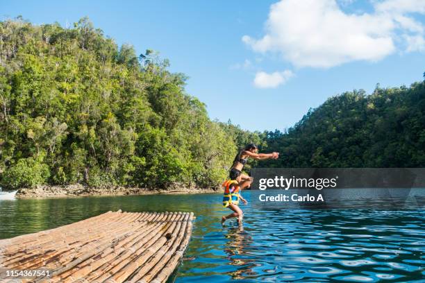 mother and daughter dive into lagoon - philippines family stock pictures, royalty-free photos & images