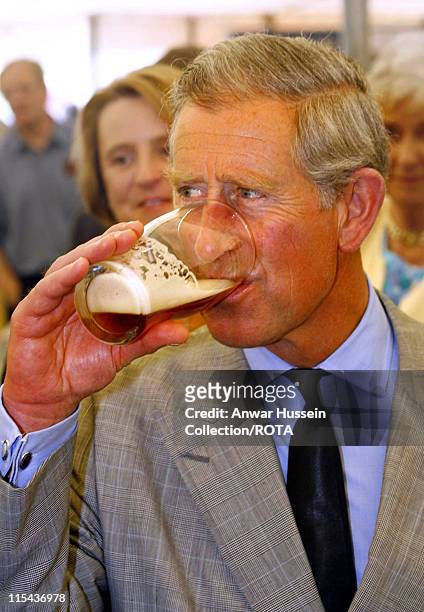 Charles, Prince of Wales samples beer from the Ring O'Bells Brewery during a visit to Showcase Launceston at Launceston Castle in the centre of the...