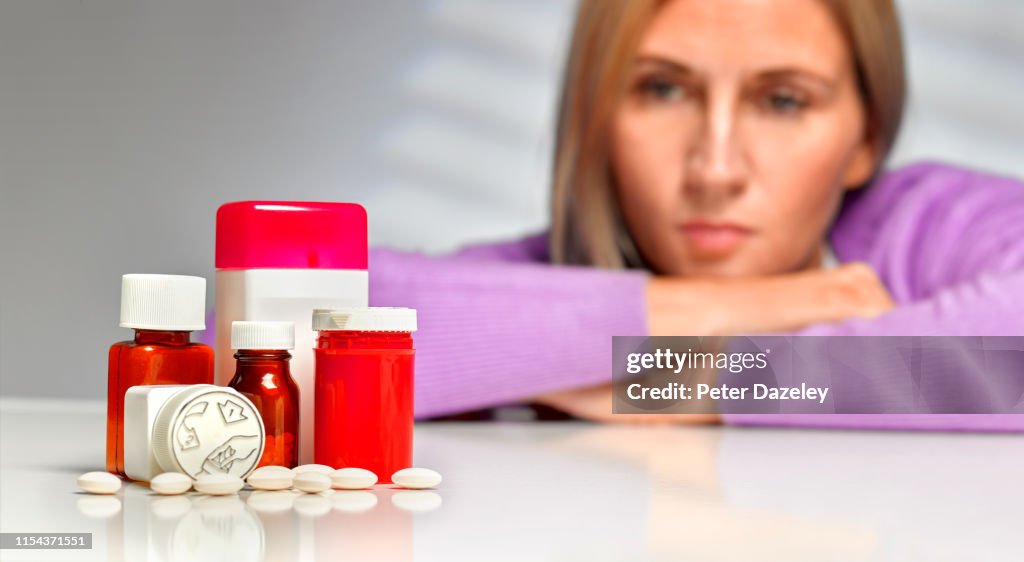 Woman looking at pills