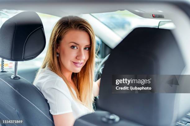 she can't help but put on a smile - driver's seat stock pictures, royalty-free photos & images