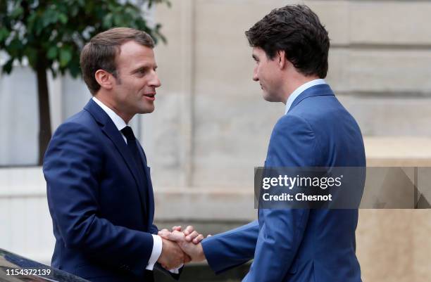 French President Emmanuel Macron accompanies Canadian Prime Minister Justin Trudeau after their meeting at the Elysee Palace on June 07, 2019 in...