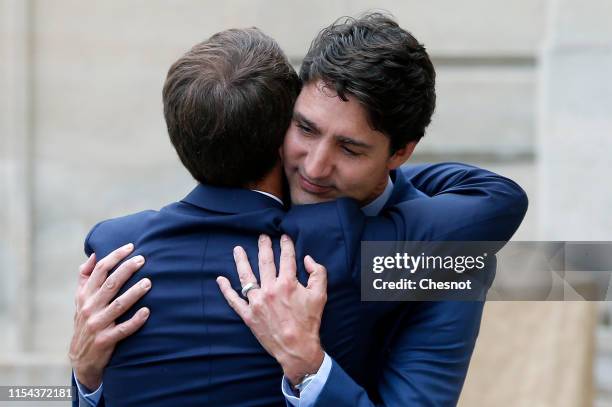 French President Emmanuel Macron accompanies Canadian Prime Minister Justin Trudeau after their meeting at the Elysee Palace on June 07, 2019 in...