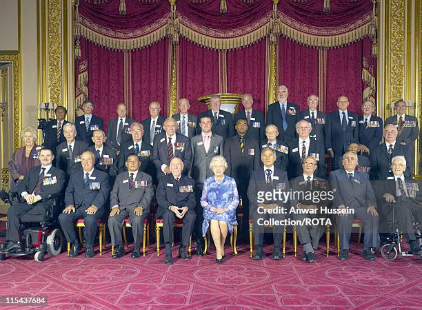 The Queen joins members of the Victoria Cross and George Cross Association for a photograph during a lunchtime reception at Windsor Castle on June...
