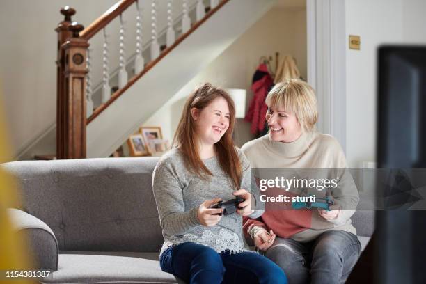 computer game mum and teenage daughter - down syndrome stock pictures, royalty-free photos & images