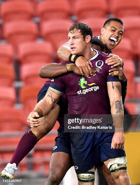 Scott Higginbotham of the Reds is congratulated by team mate Duncan Paia'aua after scoring a try during the round 17 Super Rugby match between the...