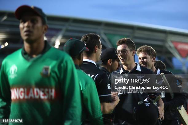 Mitchell Santner and Lockie Ferguson of New Zealand smile after they score the winning runs during the Group Stage match of the ICC Cricket World Cup...