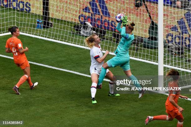 Netherlands' goalkeeper Sari van Veenendaal gets to the ball before United States' midfielder Sam Mewis the ball during the France 2019 Womens World...