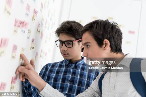 two teenage schoolboys studying - korean language stock pictures, royalty-free photos & images