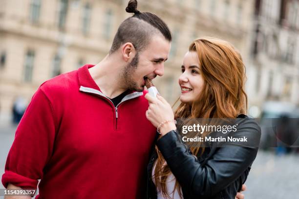 romantic woman sharing her chocolate bar - couple chocolate - fotografias e filmes do acervo