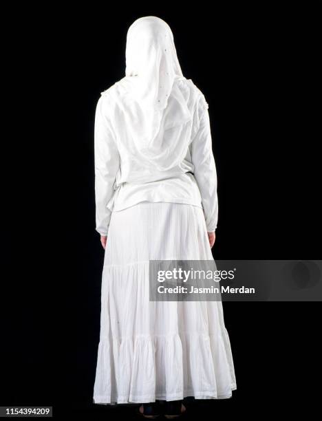 muslim woman white on black - hijab woman from behind stock pictures, royalty-free photos & images