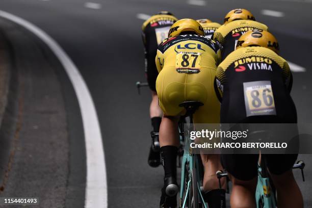 Dutch rider Mike Teunissen wearing the overall leader's yellow jersey and teammates of Netherlands' Jumbo-Visma cycling team compete in the second...