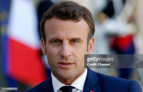 French President Emmanuel Macron makes a statement next to Swedish Prime Minister Stefan Lovfen prior to their meeting at the Elysee Palace on June...