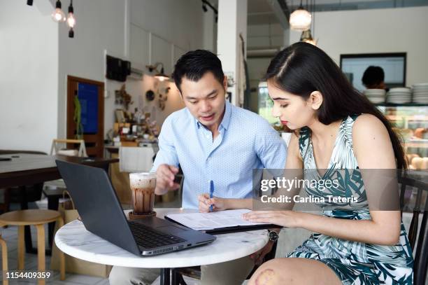 Client With Helper Financial Advisor Helping A Client With Paperwork High-Res Stock Photo ...