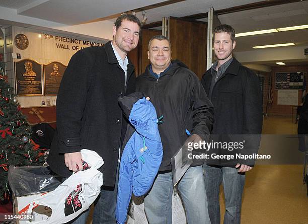 Mets pitchers Mike Pelfrey and John Maine with George Amores , who donated a coat to the 20th Annual New York Cares Coat Drive, at NYPD's 13th...