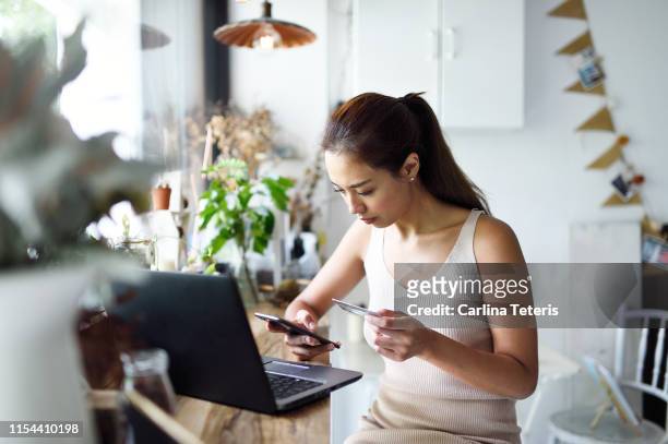 beautiful woman online shopping in a cafe - philippines women stock pictures, royalty-free photos & images