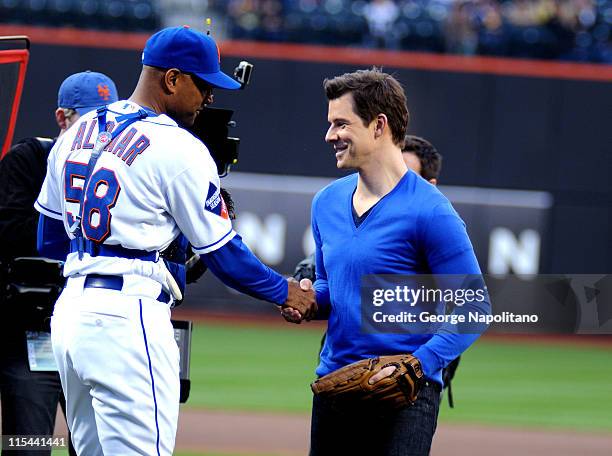 Actor Eric Mabius shakes hands with New York Mets coach Sandy Alomar Jr. Prior to the New York Mets game at Citi Field on April 24, 2009 in New York...