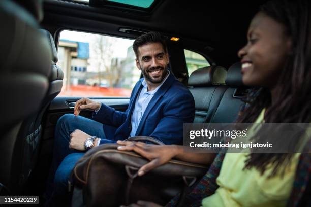 multi-ethnic couple ride sharing - ethnic woman driving a car stock pictures, royalty-free photos & images