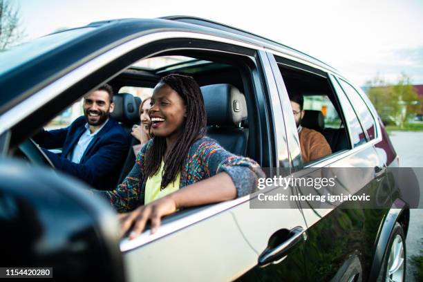 cheerful group of multi-ethnic friends on road trip - car sharing stock pictures, royalty-free photos & images