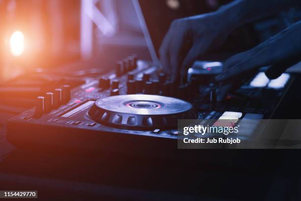 cropped hand of dj playing music at nightclub - dj deck stock pictures, royalty-free photos & images