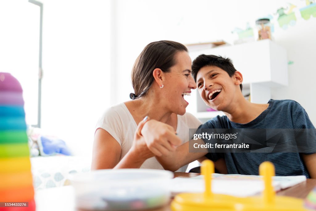 Mother playing with son with Cerebral Palsy