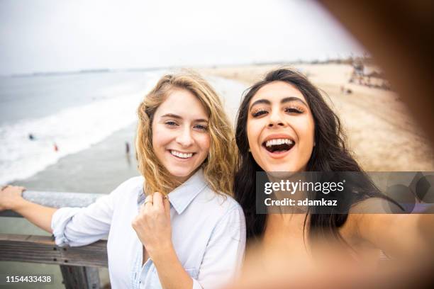 vrienden die een selfie op de pier nemen - boardwalk stockfoto's en -beelden