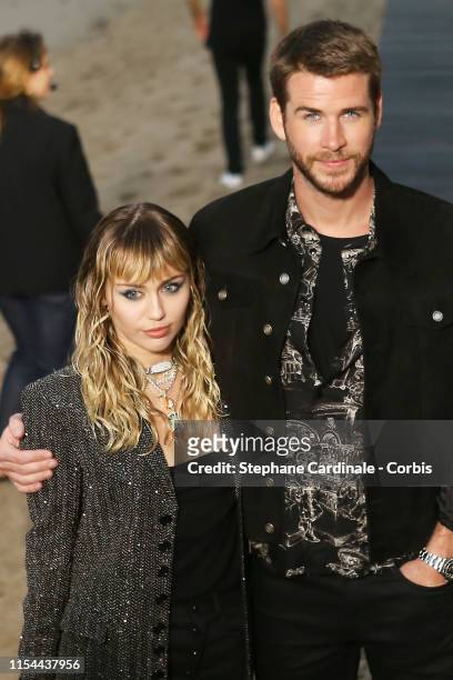 Liam Hemsworth and Miley Cyrus at Saint Laurent mens spring summer 20 show on June 06, 2019 in Malibu, California.