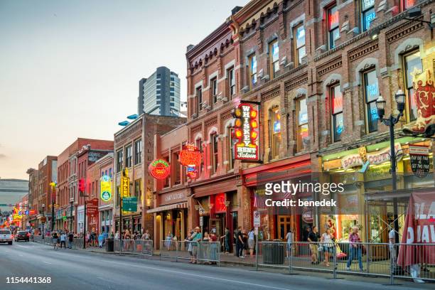 broadway pub district in downtown nashville tennessee usa - broadway street stock pictures, royalty-free photos & images