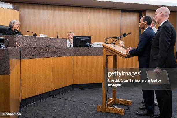 Former Minneapolis police officer Mohamed Noor, standing with his lawyers Thomas Plunkett, closest to camera, and Peter Wold, behind Noor, is...