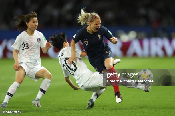 Eugenie Le Sommer of France is challenged by Hyeri Kim of Korea Republic during the 2019 FIFA Women's World Cup France group A match between France...