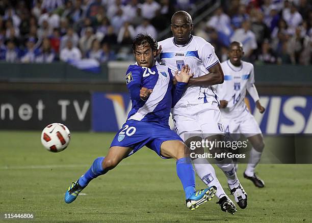Carlos Ruiz of Guatemala and Osman Chavez of Honduras battle for the ball during the first half of the CONCACAF Gold Cup first round group match at...