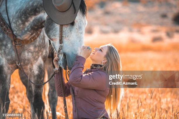 western horsewoman with companion dapple gray horse in utah grassland - western shirt stock pictures, royalty-free photos & images