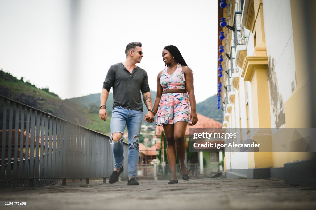 Multiethnic couple walking on the street