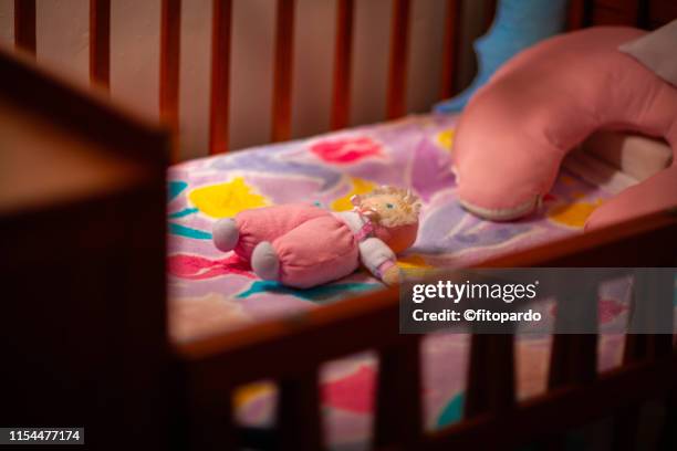 pink crib and a doll with no baby - chinese dolls stock pictures, royalty-free photos & images