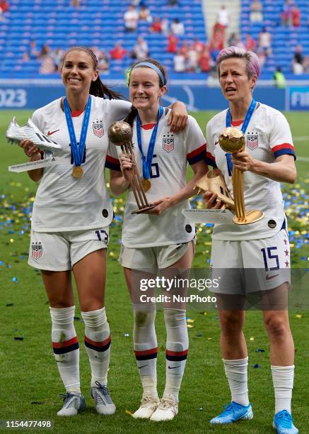 Alex Morgan silver boot, Rose Lavelle bronze ball and Megan Rapinoe golden ball and golden boot celebrate after winning the 2019 FIFA Women's World...