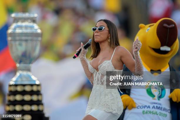 The Copa America trophy is displayed as Brazilian singer Anitta performs near the mascot of the Copa America, Zizito, during the closing ceremony of...