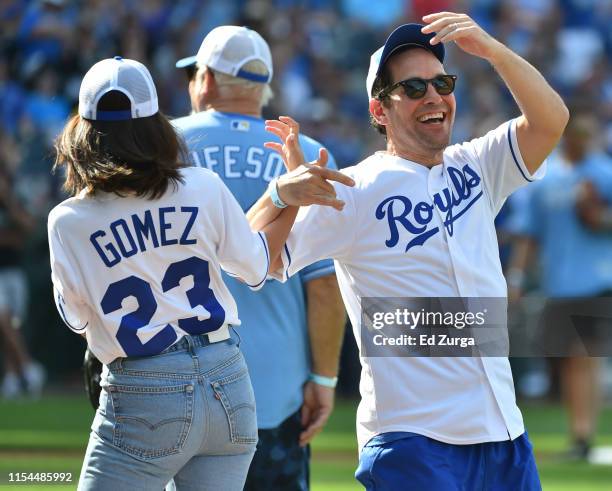 Actor Paul Rudd congratulates singer Selena Gomez after Gomez singled during the Big Slick celebrity softball game prior to game between the Chicago...