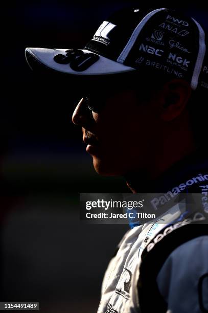 Takuma Sato of Japan, driver of the ABeam Consulting Honda, stands on the grid after posting the quickest lap during US Concrete Qualifying Day for...