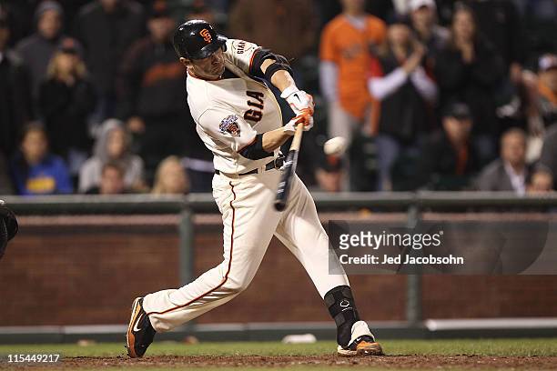 Freddy Sanchez of the San Francisco Giants connects with the winning hit in the 13th inning against the Washington Nationals during an MLB game at...