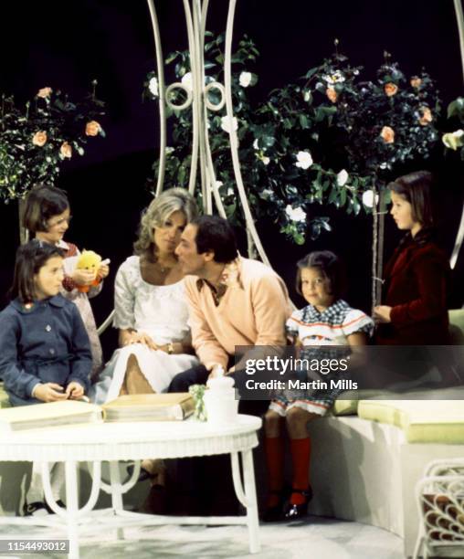 Canadian-American singer Paul Anka and his wife Anne de Zogheb sit with four of their daughters during a photo shoot circa 1970's.