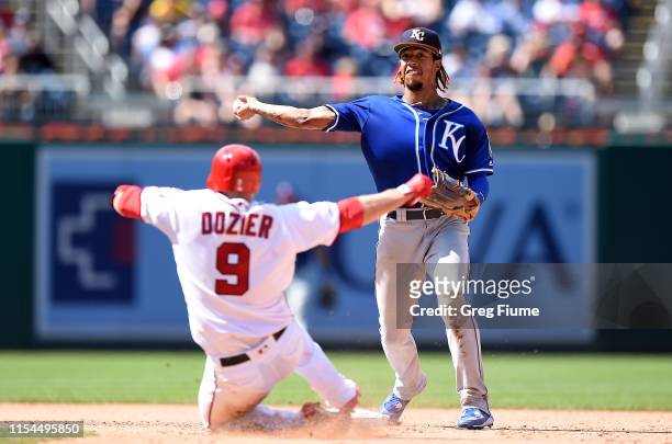 Adalberto Mondesi of the Kansas City Royals forces out Brian Dozier of the Washington Nationals to start a double play in the eighth inning at...